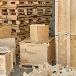 A collection of custom timber packaging solutions by Trafalgar Cases, showcasing durable plywood cases, open slatted timber crates, and specialized pallets, designed to protect and transport industrial goods efficiently.