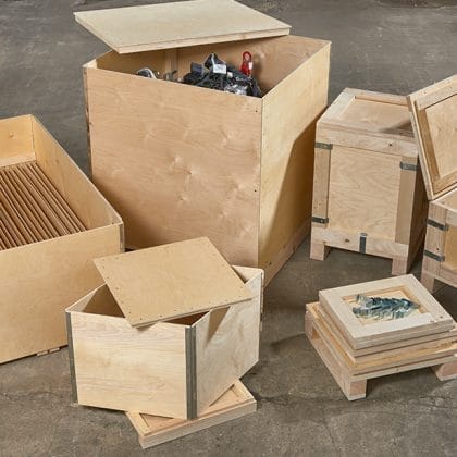 Wooden crates designed by Trafalgar Cases, showcasing a secure, tailored fit for delicate instruments, surrounded by tools and materials, emphasizing custom packaging solutions.