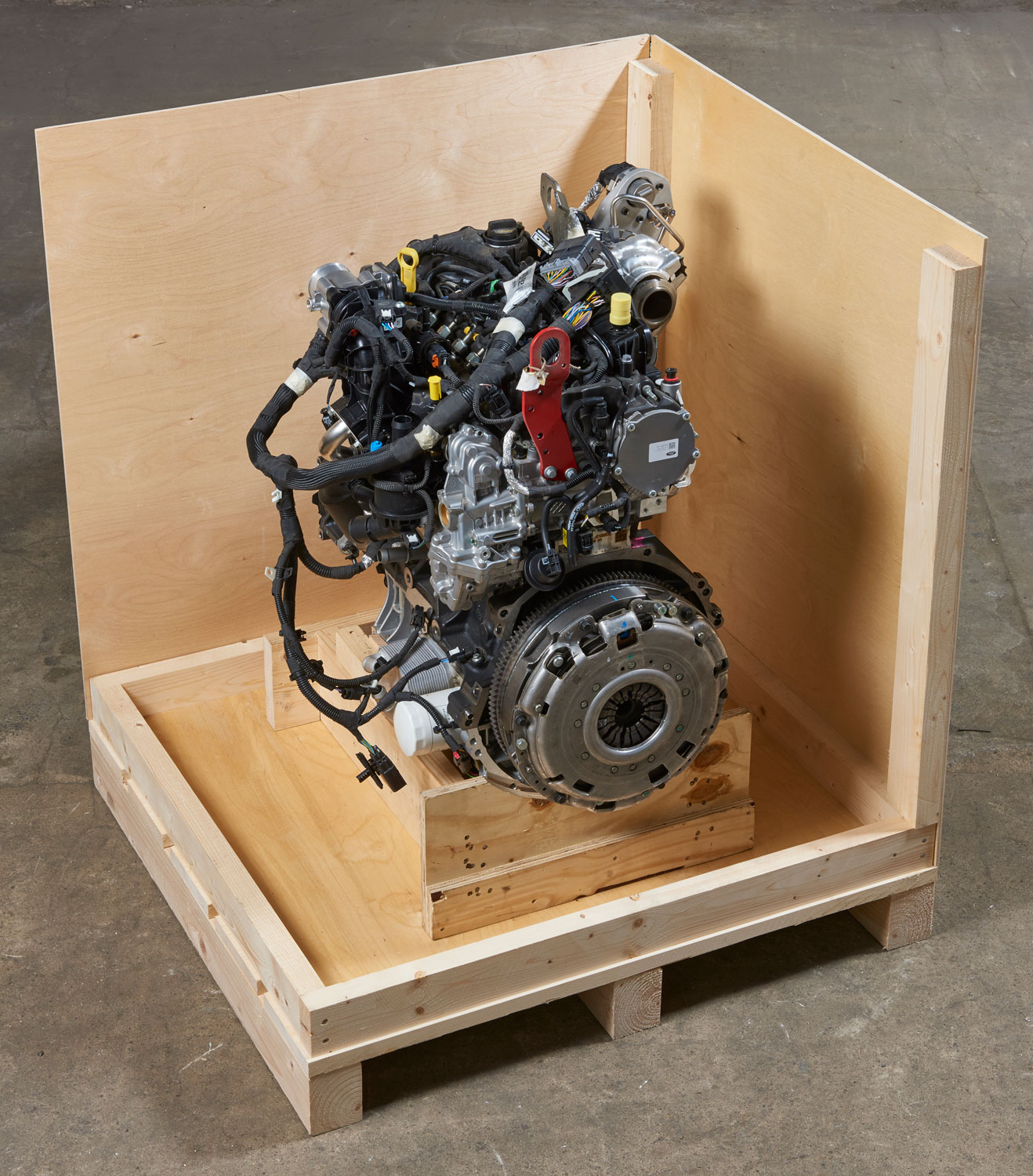 Wooden pallet base with walls to hold engine